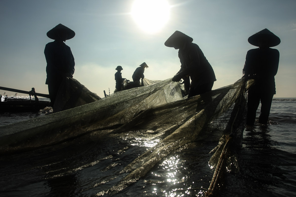 Fishermen pulling a net ashore