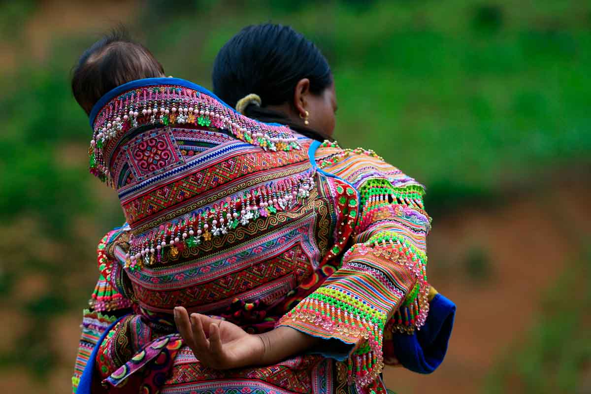 A H'mong mother carrying her baby