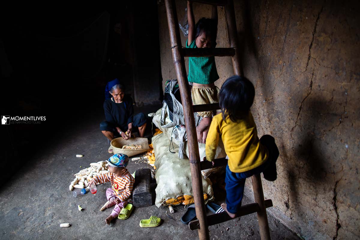 A grandmom surrounded by her grandchildren in Y Ty, Lao Cai