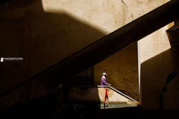 A lady walking a staircase in Dong Xuan market, Hanoi