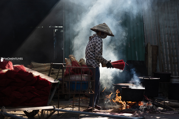 A lady drying incense in the village of Quang Phu Cau