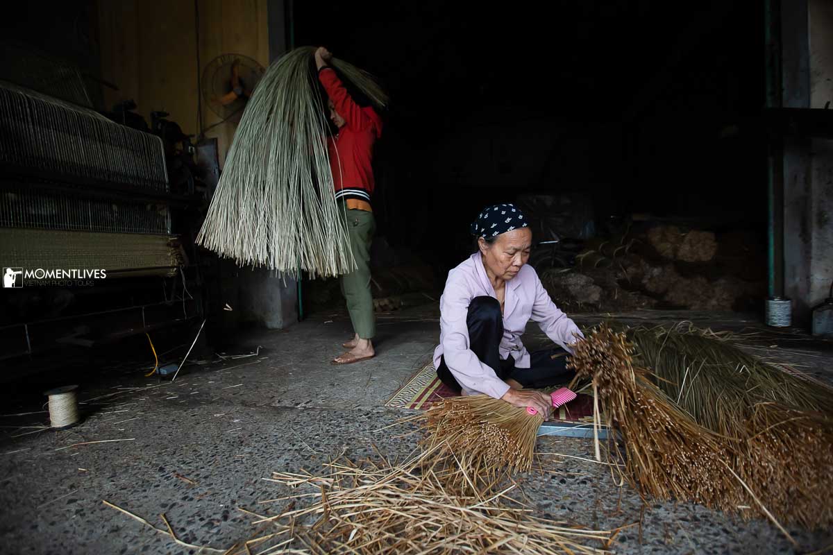 A lady brushing sedge grass in a mat weaving village, Vietnam