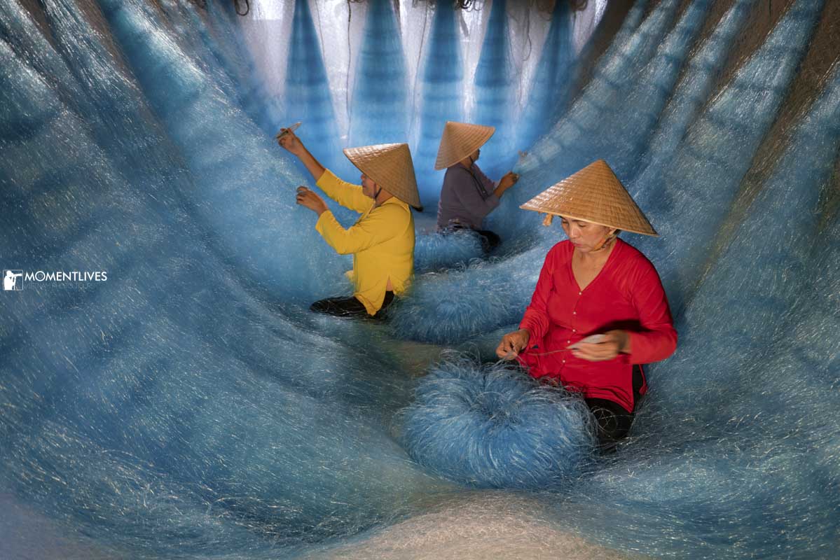 Ladies mending fishing net in Hoi An, Vietnam