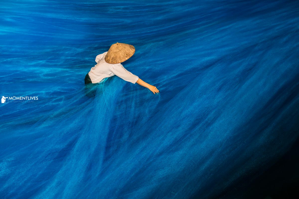 A women tending a fishing net in the countryside of Vietnam