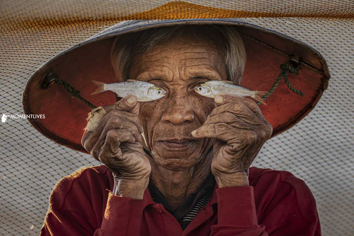 Fisherman playing with fish in Hoi An, Vietnam
