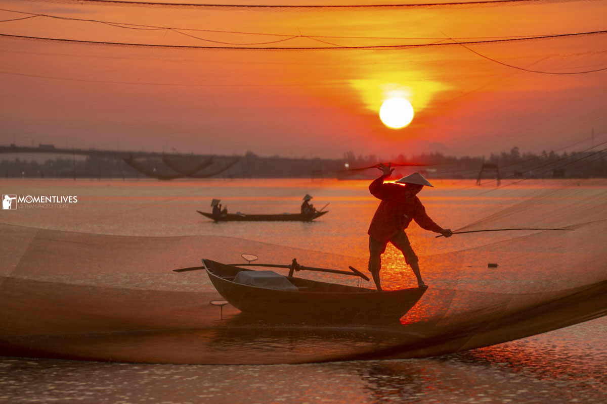 A fisherman tending his fishing net in the golden hour
