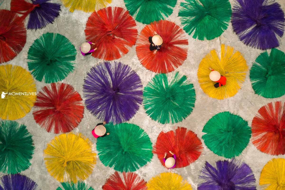 Ladies drying sedge grass in the act of making mats