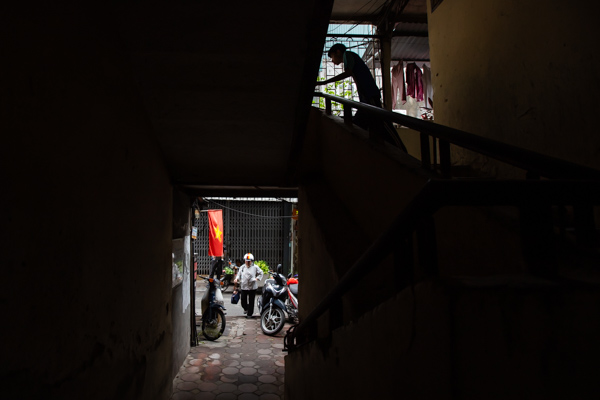 An old staircase with a woman walking in an a man walking out