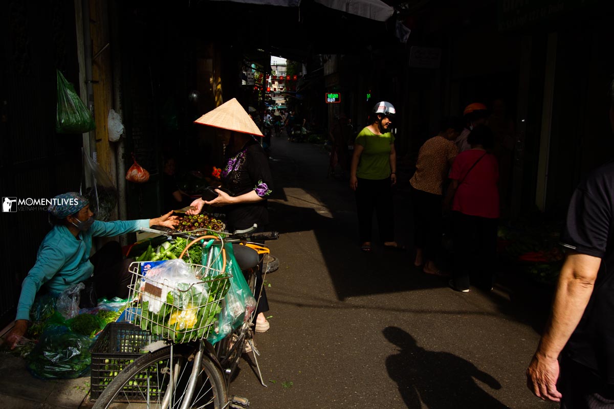 A lady shopping in a morning open market in Hanoi