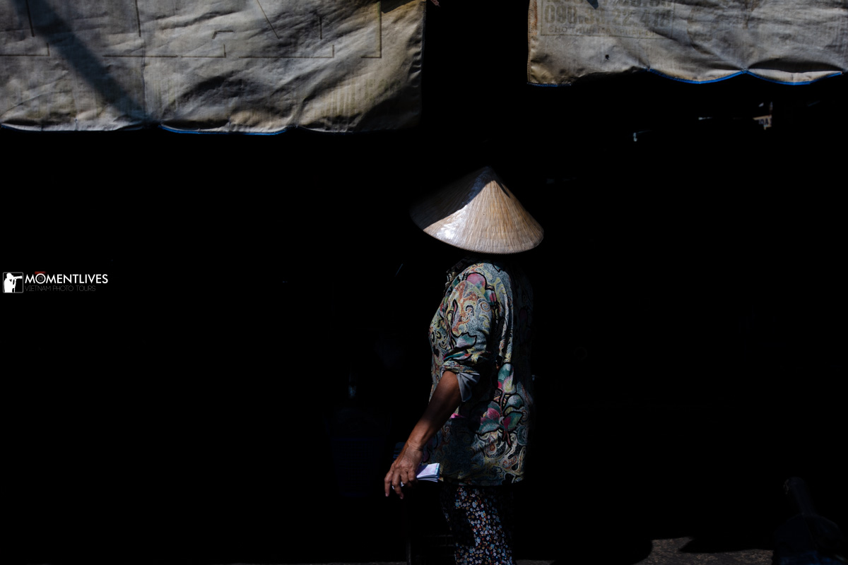 Lady wearing conical hat in Sa Dec market