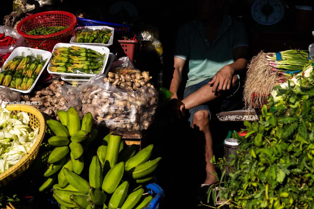 Man selling fruits and veges in a market in Sa Dec