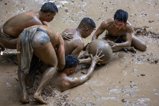 The goal keeper at the mudball match trying to defense