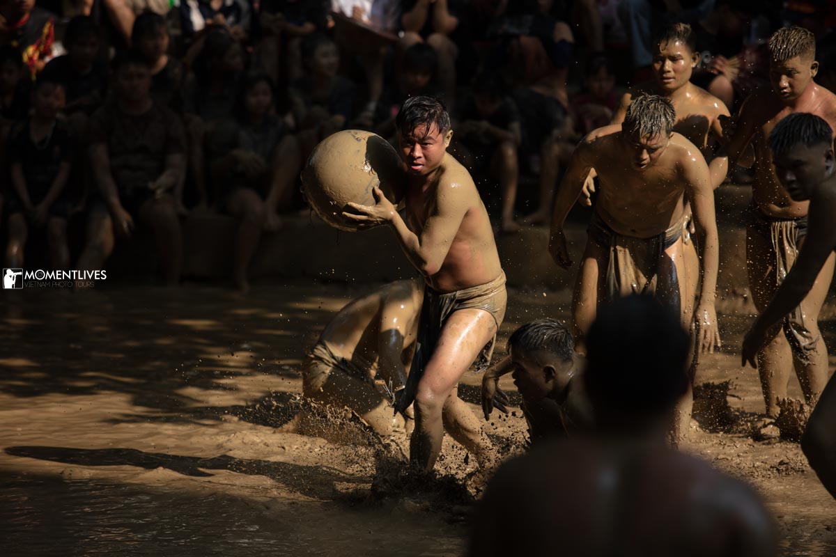 Group of men playing in the mudball festival in Bac Giang