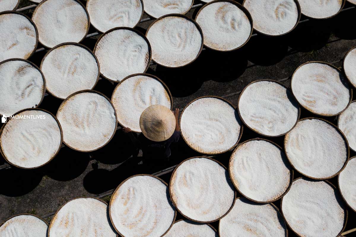 A man drying cassava flour in Tay Ninh, Vietnam
