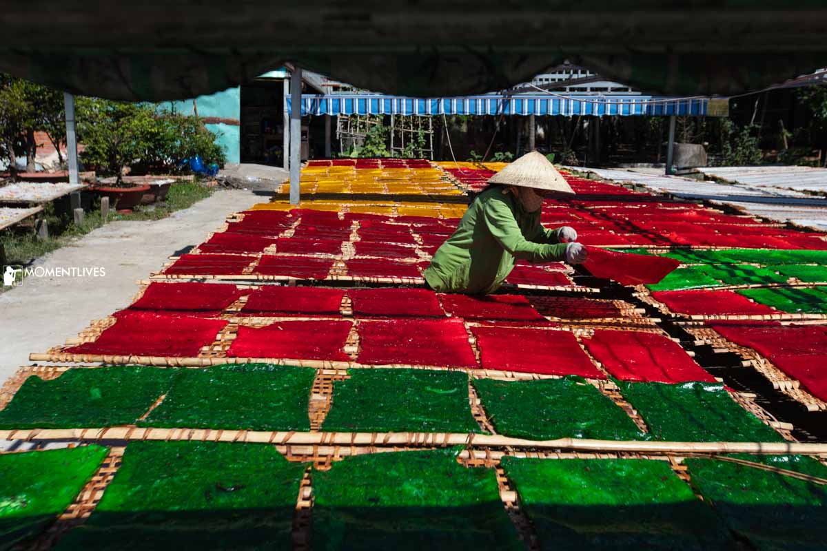 Lady drying cassava starch sheets in Tay Ninh
