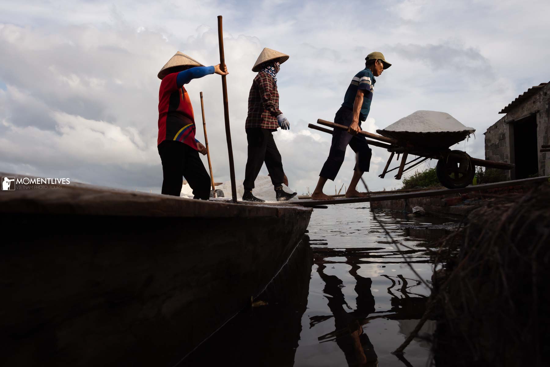 Farmers moving salt in the salt fields of Nam Dinh