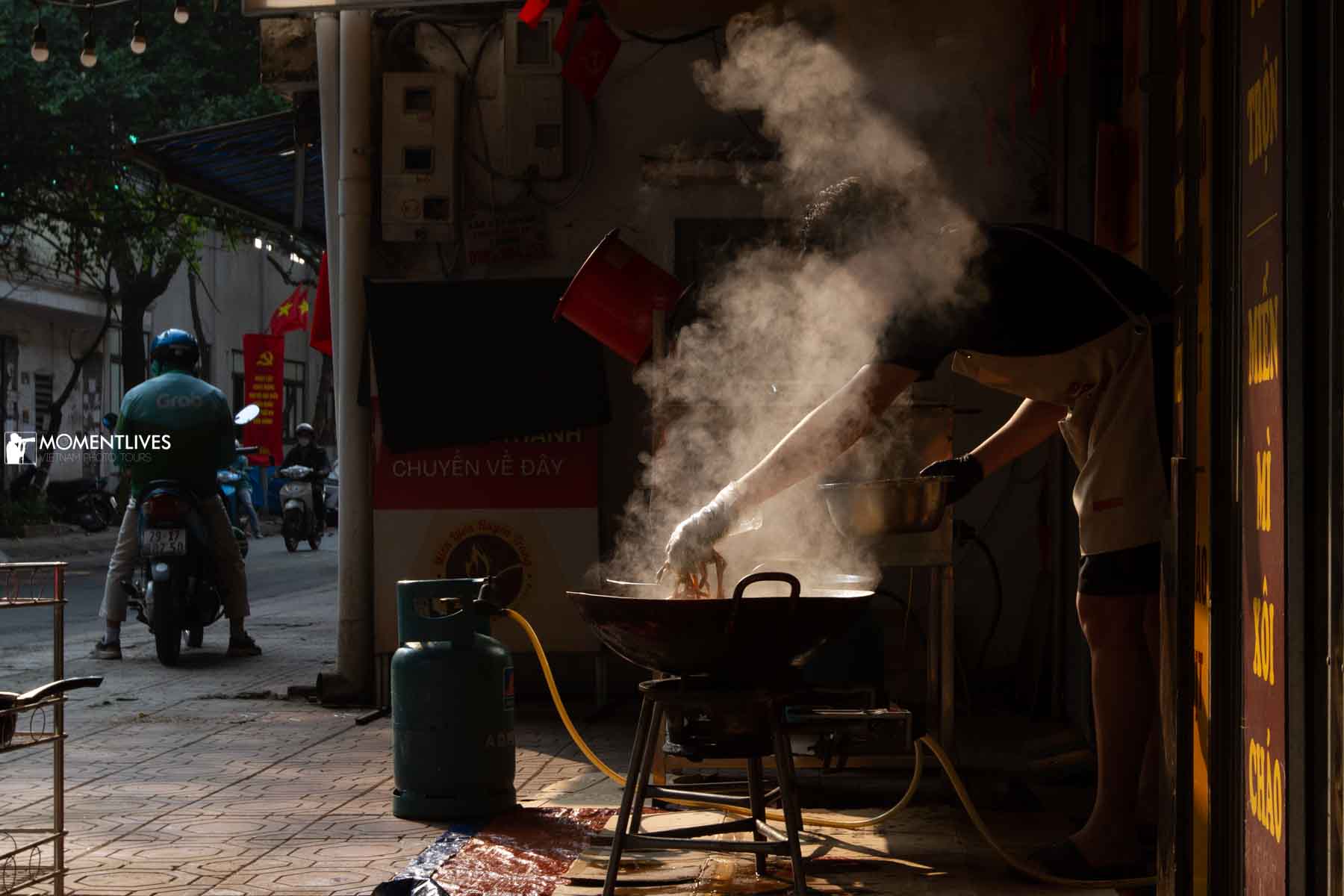 Man cooking on the side of the street in Hanoi