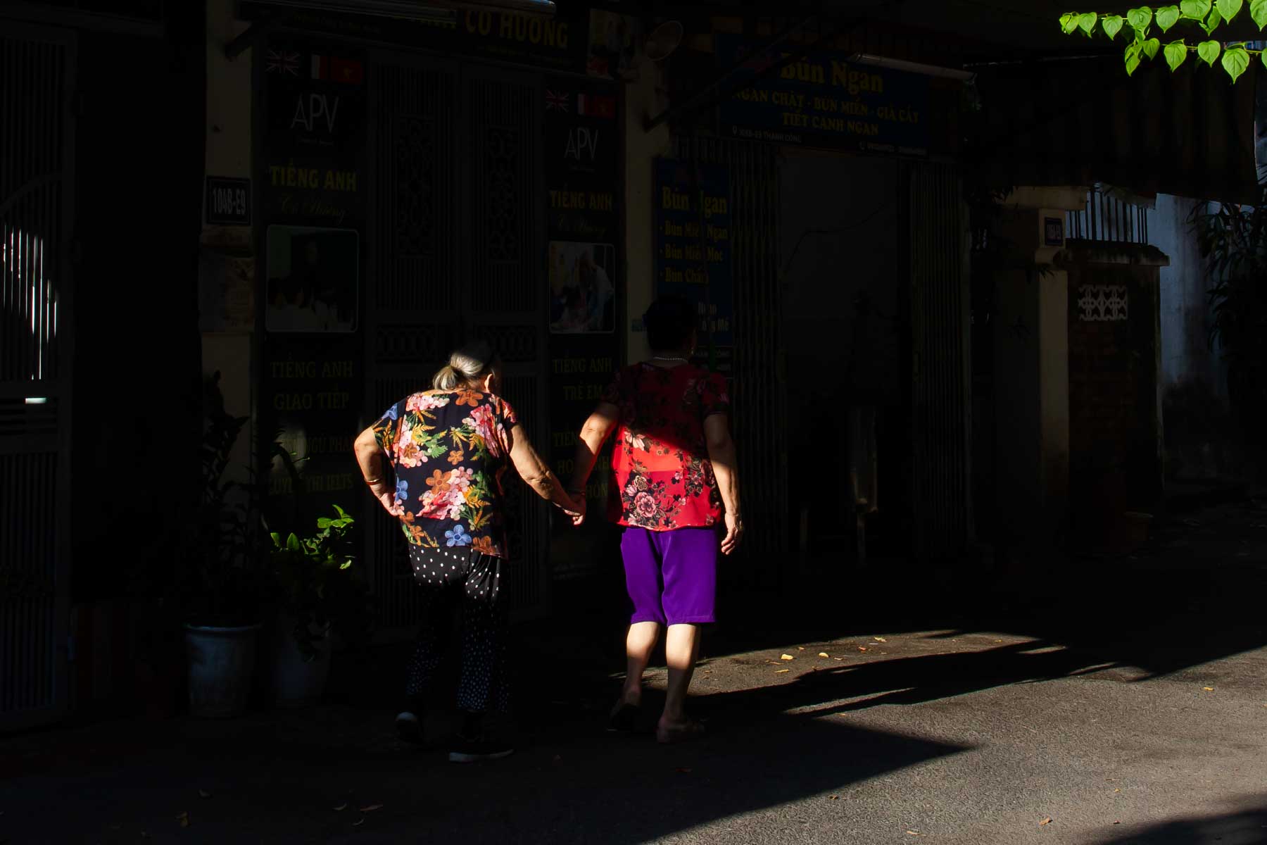 Friends walking hand in hand in Hanoi